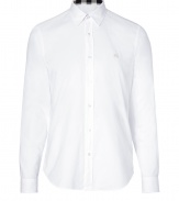 Casual and cool with its classic styling and super soft cotton, Burberry Brits white button-down is a timeless choice for all 4 seasons - Cutaway collar, long sleeves, buttoned cuffs, button-down front, tonal embroidered logo at chest, shirttail hemline - Classic straight silhouette - Wear with chinos and bright leather loafers