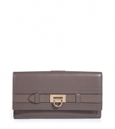 Elegant wallet in supple taupe leather - A standout, ladylike luxe accessory from Salvatore Ferragamo - Classic style, smart design - Oblong envelope shape with flap - Interior zip pocket,  room for coins, bills and credit cards - Chic hardware logo detail - Timeless and sophisticated, great as a gift for you or someone else