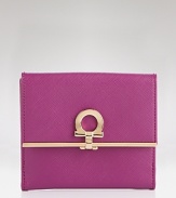 A luxe trifold wallet in textured leather with signature lock detail from Salvatore Ferragamo.