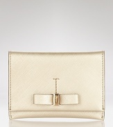 With a sleek attached bow, this classic Salvatore Ferragamo Saffiano card case makes a chic statement of luxury.