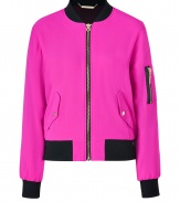 Work a fun edge into your outfit with Juicy Coutures bright pink bomber jacket - Soft chiffon exterior, black knit collar, long sleeves with aviator-style zip pocket, black knit cuffs, gold-toned front zip, snapped flap pockets, black knit hemline - Loosely fitted, tapered hemline, shorter cut - Wear with jet black skinnies and tissue tees, or over your favorite Little Black Dress