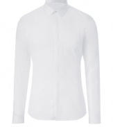 Sleek and streamlined, Belstaffs white cotton poplin shirt is a modern must in any wardrobe - New slim cut fits snugly and tapers gently through waist - Covered full button placket and chest pocket - Small collar and long, cuffed sleeves - Pleat detail at back - Wear solo or beneath a blazer or leather jacket, and pair with dress trousers, dark denim or chinos