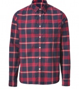 Rugged looks get a cool finish in Woolrichs red and navy plaid button-down - Classic cut, buttoned cuffs, breast pocket, shirttail hemline - Team with jeans and rugged boots