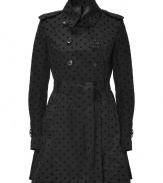 Stay stylish and sweet in Valentino R.E.Ds black nylon trench, detailed with velvet dots and a fun flounce for playfully chic results we love! - Classic trench styling, double-breasted button-down front, self-tie sash around the waist - Fitted and flared silhouette - Wear over cocktail frocks with heels and a leather clutch