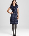 A study in classic feminine style, this Tory Burch dress flaunts a charming plaid print and a delicately ruffled front for effortless polish. Just add a dash of pearls and prepare to head the fashion class.