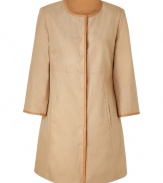 This modern-styled coat fuses has a fashion-minded fit and luxe detailing - Rounded collar, leather detailed front seam, concealed snap front closure, slit pockets, slightly belled sleeves - Style with wide leg trousers, a sheer blouse, and platforms