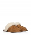 Cozy chestnut slippers from Ugg Australia - These luxe slippers feature supple light brown suede and a comfy lambs wool lining - Stylish seaming down the front with Ugg logo - Stay warm and stylish in these lovely slip-ons