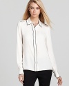 Rachel Zoe reinvents the classic button down with chic contrast piping and shoulder-squaring epaulets.