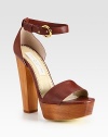 An adjustable ankle strap wraps around this chic faux leather design, resting on a tall wooden platform heel. Wooden heel, 5½ (140mm)Wooden platform, 1¼ (30mm)Compares to a 4¼ heel (110mm)Faux leather upperFaux leather liningRubber trek solePadded insoleMade in ItalyThis style runs large. We recommend ordering one half size down for a standard fit. 