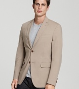 A classic two-button closure and a sleek fit define the timeless style of this luxe Salvatore Ferragamo blazer in a versatile tan hue.