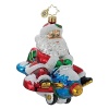 Santa takes an alternate mode of transportation to deliver toys, hitching a ride on a blue jet.