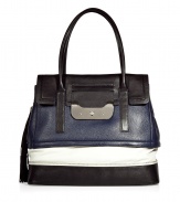 Chic handbag in supple, fashionably colorblocked leather - Bold and sophisticated in black, navy and white - Structured flap top silhouette with detachable tassel and zipper embellishments - Two top handles and silver metal turnlock closure - Outer zip compartment and protective metal feet - Lined in cotton, with one interior zip pocket and two open pockets - Seamlessly transitions from work to weekend