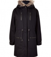 A traditional-style parka gets a modern update with clean lines and fur trim - Features a raccoon fur-trimmed hood, hidden zip closure, drawstring waist, patch and slit pockets at the front - Long sleeves with adjustable snap cuffs for added warmth - Long length for a season of comfort on the coldest days - Pair with slim jeans and favorite knee-high boots