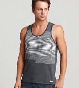 A unique, optically intriguing print of varying stripes is color-blocked on a soft cotton tank for a chilled-out, on-trend warm weather look.