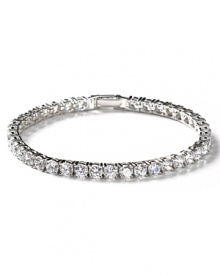 This enchanting round-cut tennis bracelet features hand-set cubic zirconia and a pure platinum finish. Five petite round stones adorn the clasp.