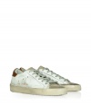 Modeled after vintage tennis shoes, this high-end version from Golden Goose will add an instant upgrade to your casual-cool style - Round suede toe, lace-up front, leather upper with perforated side star detail, contrasting embossed leather logo detail, stylishly distressed rubber sole - Style with skinny jeans, a mini-skirt, or cut off denim shorts