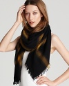 A large woven wool scarf with a chic ombré check pattern and twisted fringe ends.