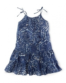 A bohemian-inspired batik print accents the ruffled hem of a pretty sundress for effortless summer style.