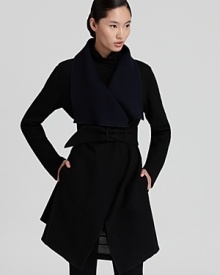 This oversized Donna Karan New York coat is cinched with a fabric belt for a louche fit that's effortlessly flattering for a season of standout looks. Wear the reversible style on its black side workdays and ink side come weekends.