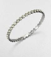 Lovely faceted glass stones with a radiant silvery tint are dotted along a slender bangle with a polished finish.GlassSilvertoneDiameter, about 2.5Imported