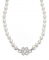 Professional poise. Lauren by Ralph Lauren's polished necklace adds a dignified element to any look. A single strand of glass pearls highlights a scroll pendant accented by pave-set glass accents. Set in silver tone mixed metal with a lobster claw clasp. Approximate length: 18 inches.