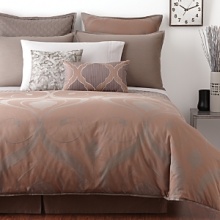 Engineered embroidery and refined silk textures on decorative pillows add the finishing touch.