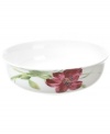 Painterly lilies bloom around this porcelain vegetable bowl, creating a beautiful arrangement with the rest of Oleg Cassini's Sweet Blossom dinnerware.