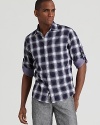 Tailored for a slim, modern fit, the classic plaid pattern of this Michael Kors sport shirt receives a touch of contrast when the sleeves are cuffed.