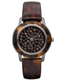 A modern watch design from DKNY with eye-catching neutral-hued stones at the dial.