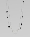 A long, delicate piece with beautiful round black agate stations on one of the two sterling silver link chains. Black agateSterling silverLength, about 39¾Clasp closureImported 