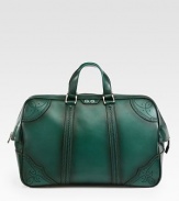 Green hand-stained leather duffel with perforated trim detail.Top zip closureLeather top handleInside pocket with a Gucci crest zipperFive metal feetVelvet Diamante liningLeather20.5W x 12.2H x 8DMade in Italy