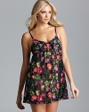 Go for girlishness in this floral print chiffon slip with contrast rosette appliqués along neckline and ruffle trim.