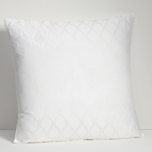 Embroidered and embellished decorative pillows complement the bedding ensemble.