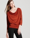 This Eileen Fisher boxy top flaunts a soft, draped neckline and relaxed silhouette that finishes in a cuffed waistband and hem.