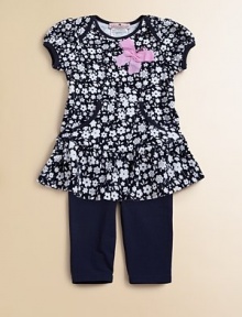 A floral ruffled tunic with pockets complements a matching pair of soft leggings.Envelope necklineShort cap sleevesPullover styleKangaroo pocketsSkirted hemElastic waistbandLogo embroideryTunic: 65% cotton/35% rayonLeggings: 94% cotton/6% spandexMachine washImportedAdditional InformationKid's Apparel Size Guide 