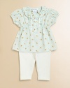 This floral cotton tunic & leggings set embodies sweet, feminine style with delicate lace, pretty ruffles and embroidered Swiss dots.Ruffled crewneckShort puffed sleevesButton front placket adorned with ruffles and laceTunic has elastic waistGently flared hemLeggings have elastic waistCottonMachine washImported Please note: Number of buttons/snaps may vary depending on size ordered. 