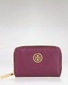 Tory Burch's leather pouch is a petite yet polished choice. Crafted of leather and adorned with a subtle designer plaque, it encapsulates the brand's city sleek approach to accessorizing.