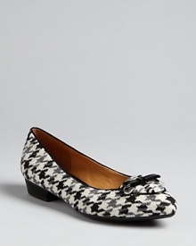 Patent piping pops against natty houndstooth in these Isaac Mizrahi flats, featuring this season's must-have pointed toe silhouette. They're perfect, workday or weekend.