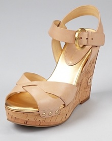 Neutral-hued leather makes a natural pairing with a cork wedge on the leg-lengthening Halina sandal from IVANKA TRUMP.