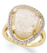 The golden rule. This stunning statement ring features an asymmetrical golden rutilated quartz (6-3/4 ct. t.w) that shines against a sparkling diamond frame (1/6 ct. t.w.). Set in 14k gold over sterling silver. Size 7.