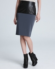 This Jean Paul Gaultier puts a forward spin on a classic look adding a sleek leather panel to a stretch pencil skirt for the ultimate example of day-to-night style.