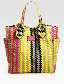 This vibrant carryall features signature letter stitching on printed nylon, complete with large over-sized pockets and knotted handles. Double top handles, 7½ dropMagnetic top closureTwo outside open pocketsOne inside zip pocketTwo inside open pocketsLogo-print lining14½W X 14½H X 4¼DImported