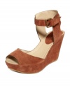 Characterized by its smooth suede and ultra-femme wrapped wedge, this strappy ankle platform sandal from Kenneth Cole Reaction is sure to infuse any warm-weather ensemble with fierce flair.