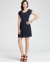 Ladylike eyelet decorates a knit Aqua dress touting the season's must-have pleated skirt for a delightful daytime look.