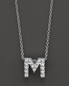 From the Tiny Treasures collection, a diamond M necklace. With signature ruby accent. Designed by Roberto Coin.