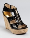 A gold-tone zipper adds a unique detail to MICHAEL Michael Kors Damita wedges, a versatile summer style that's professional at the office and provocative after hours.