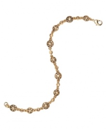 Warm, golden hues make this Monet bracelet an office staple or a touch of evening elegance. Crafted in goldtone mixed metal, links of circular medallions feature rosy, topaz-colored crystals. Approximate length: 8 inches.