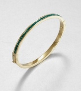 From the Cocktail Collection. Meticulously faceted, emerald-colored stones line one side of this slender bangle, in deep contrast to the other side of polished goldtone.GlassGoldtoneDiameter, about 2.5Hinged with push-lock claspImported