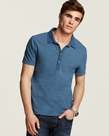 Updated polo with slim fit, extra long button placket and allover slub texture.