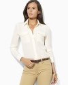 Inspired by rugged safari looks, the classic shirt is updated for chic femininity in airy, fluid silk.